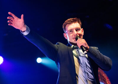 Emmet Cahill on stage singing at the King John Summer Prom Festival