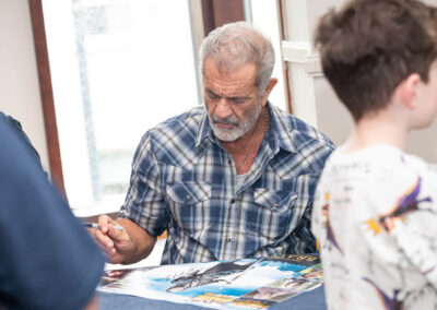 Mel Gibson signing posters for fans